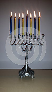 Hanukkah lamp with yellow and blue candles