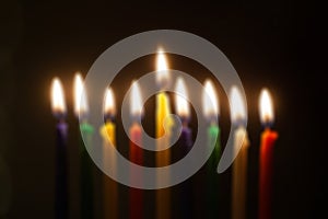 Hanukkah menorah, or hanukkiah with colored candles is out of focus. Jewish holiday Hanukkah blurred background.