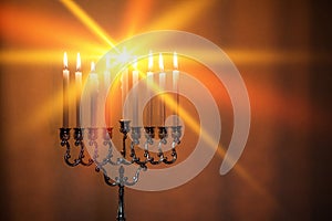 Hanukkah menorah, or hanukkiah in the light of the sun at sunset for Jewish holiday Hanukkah.