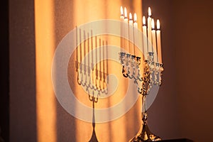 Hanukkah menorah, or hanukkiah in the light of the sun at sunset for Jewish holiday Hanukkah.