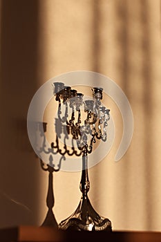 Hanukkah menorah, or hanukkiah in the light of the sun at sunset for Jewish holiday Hanukkah.