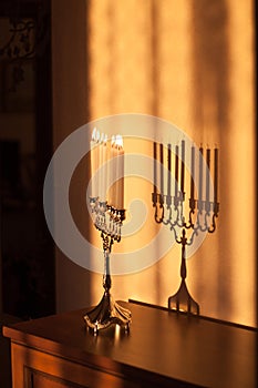 Hanukkah menorah, or hanukkiah in the light of the sun at sunset for Jewish holiday Hanukkah.