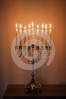 Hanukkah menorah, or hanukkiah in the light of the sun at sunset for Jewish holiday Hanukkah.