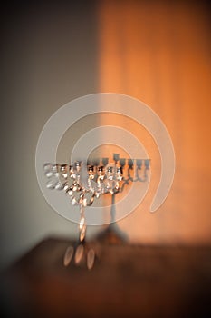 Hanukkah menorah, or hanukkiah in the light of the sun at sunset for Jewish holiday Hanukkah.