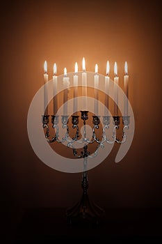 Hanukkah menorah, or hanukkiah in the light of the sun at sunset for Jewish holiday Hanukkah.