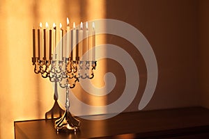 Hanukkah menorah, or hanukkiah in the light of the sun at sunset for Jewish holiday Hanukkah.