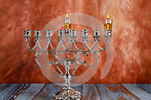 jewish holiday Hanukkah with lighting the first candle on a hanukkah menorah traditional candelabra photo