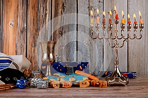 jewish holiday Hanukkah with menorah traditional Candelabra and wooden dreidels spinning photo