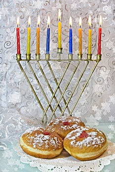 Hanukkah menorah and traditional doughnuts