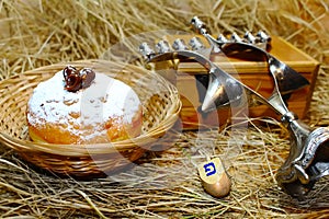 Hanukkah symbols: doughnut Sufganiyah or Sufganiyot,  spinning top Dreidel and Menorah. Hanukkah -  Jewish holiday in Israel