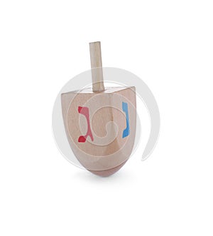 Wooden Hanukkah traditional dreidel with letters Nun and Gimel isolated on white