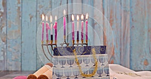 Hanukkiah Menorah with candles burning is a traditional symbol of Jewish faith during holiday Hanukkah