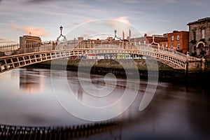 Hapenny Bridge over the Liffey River long exposure at sunset