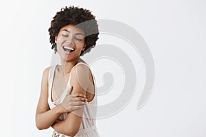 Hapiness comes with good health. Good-looking emotive and tender feminine African American with afro hairstyle in trendy