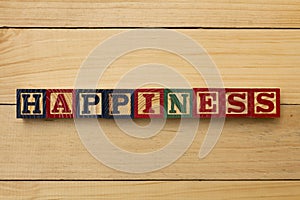 Hapiness wood cube words on wooden table cool