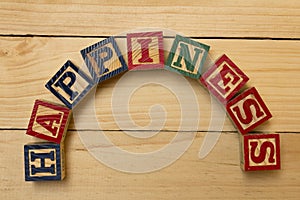 Hapiness wood cube words on wooden table cool