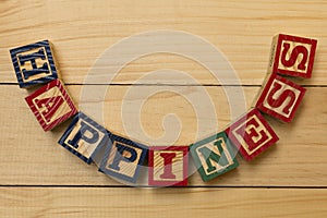 Hapiness wood cube words on wooden table cool