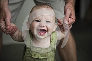 Happiest little baby boy learning to walk