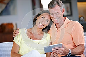 Happiest when theyre together. a loving mature couple using a digital tablet at home.