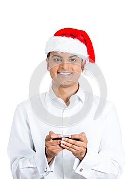 Happily browsing handsome man in red santa hat