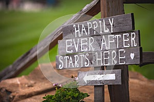Happily Ever After Starts Here sign at wedding venue photo