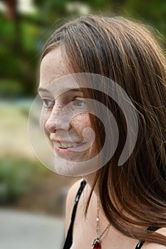 Happily  laughing teenage girl with a lot of freckles