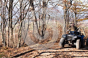 Happily riding the Atv Quad Bike on the Mountains Road