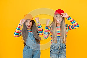 Happiness ahead. Happy small girls enjoying happiness together on yellow background. Little kids with cute smiles