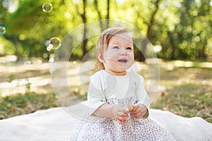 Happiness Baby girls sitting in the park with sunlights