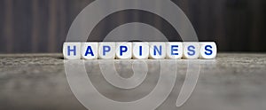 Happiness boggle word cubes on dark background