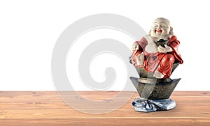happiness chinese god statue smiling and sitting on antique gold ingot on shelf isolated on white background with copy space