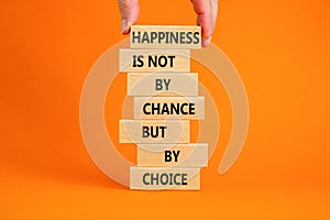 Happiness is choice symbol. Wooden blocks with words Happiness is not by chance but by choice. Beautiful orange background copy