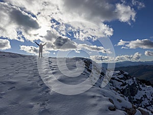 The happiness of the climber at the top of the snowy mountains