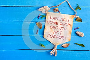 Happiness come from growth not comfort text on Paper Scroll photo