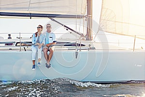 Happiness comes in salty water. a couple enjoying a boat cruise out on the ocean.