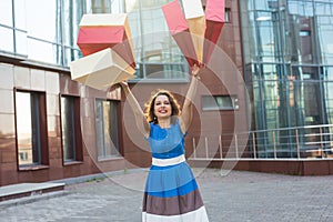 Happiness, consumerism, sale and people concept - woman with shopping bags