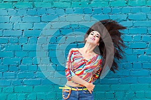 Happiness and craziness. Smiling funny girl have fun outdoor and dances. Young attractive woman with waving long hair
