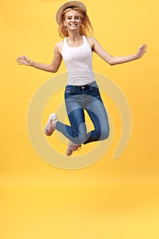 Happiness, dream, fun, joy, summer concept. Very excited happy cute caucasian teen is jumping up, in summer outfit, hat