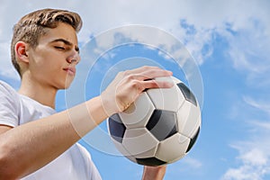 Happiness football player with ball and blue sky