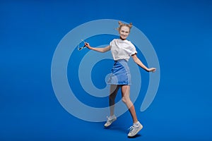 Happiness, freedom, motion and people concept - smiling young woman jumping in air over white background