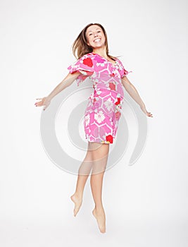 Happiness, freedom and people concept - smiling young woman jump