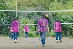 Happiness group of teenage friends playing volleyball