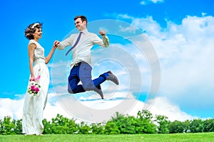 Happiness is in her hands: young and handsome bridegroom is fluttering in the air. Blue pants