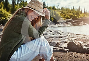 Happiness is inevitable when youre in nature. a young woman spending a day at the lake.
