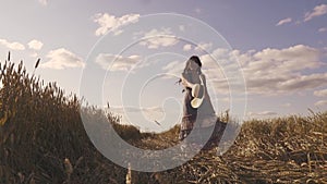 Happiness and joy young woman who turns on a wheat field smiling. slow motion