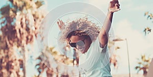 Happiness and joyful portrait of happy woman jump outdoor smiling and having fun alone - trees and outdoors leisure activity with