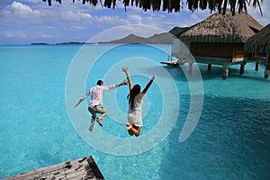 Happiness jump of young couple photo