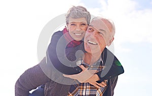 Happiness keeps the spirit young. Portrait of a happy senior couple enjoying a piggyback ride outdoors.