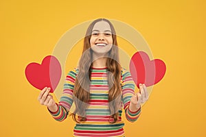 Happiness kids and love concept. Romantic lovely teen girl with red heart, world heart day, happy valentines day.