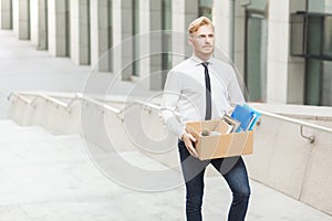 Happiness manager have a new job. Well dressed red hair young adult worker, going to new better work. Outdoor shot in stairs, move